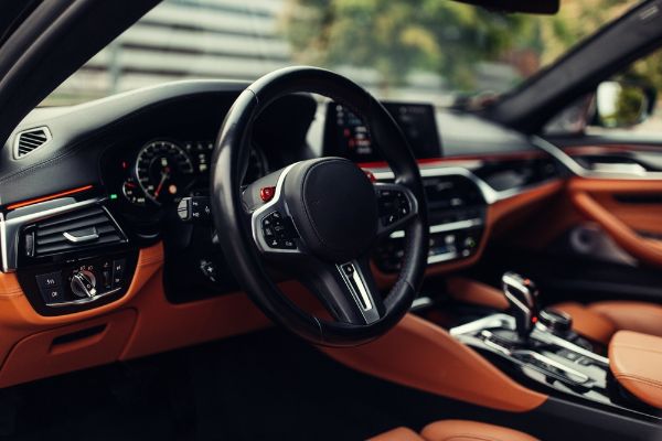 Modern supercar interior with leather panel, sport seats, multimedia and digital dashboard