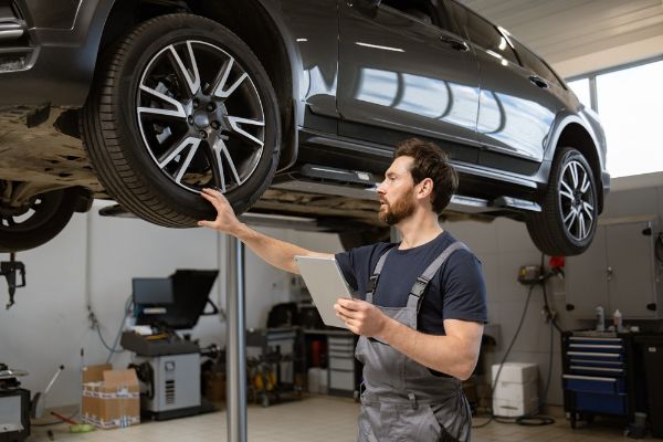 man inspecting tires