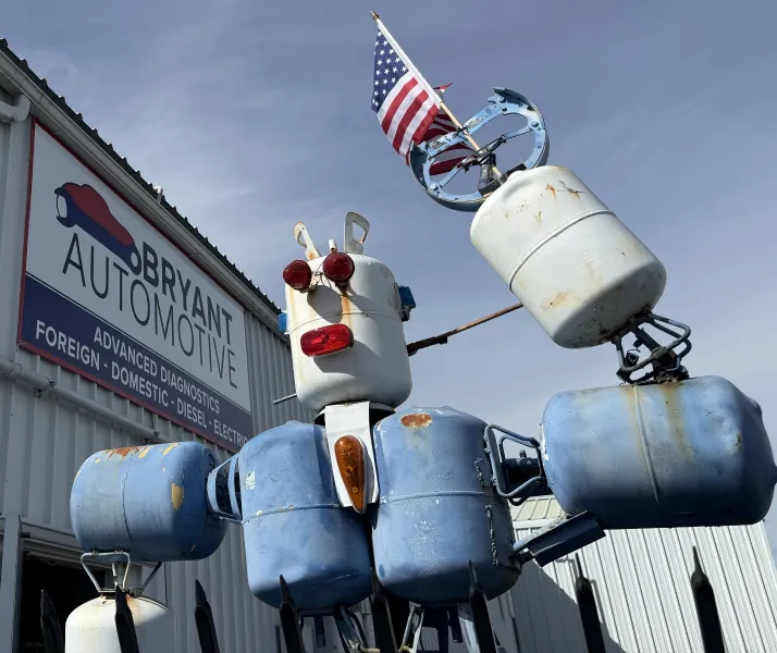 Barry-Bot, the Bryant Automotive mascot robot, outside the shop on Churn Creek Road